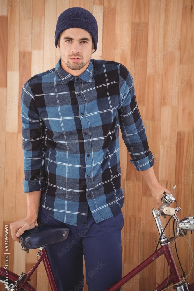 Portrait of hipster standing with bicycle Portrait of hipster standing with bicycle