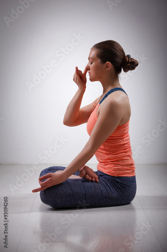 Sporty fit yogini woman practices yoga pranayama breath control 