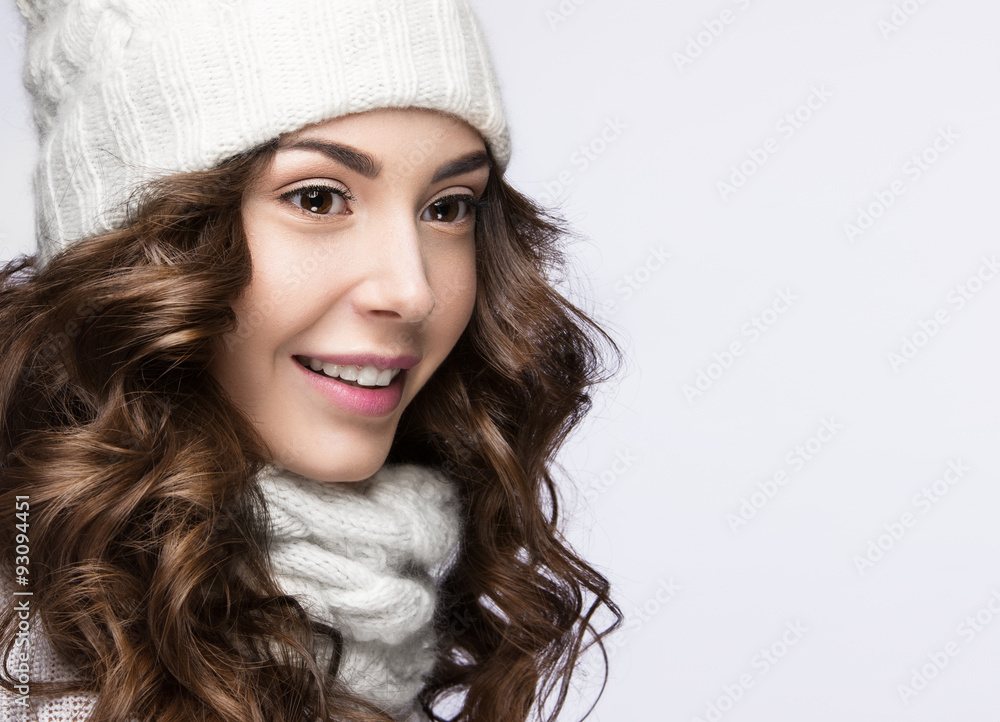 Beautiful girl with gentle makeup, curls and smile in white knit Beautiful girl with gentle makeup, curls and smile in white knit