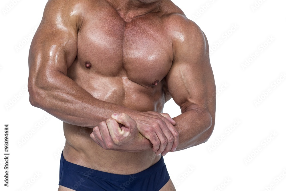 Midsection of shirtless man flexing  muscles