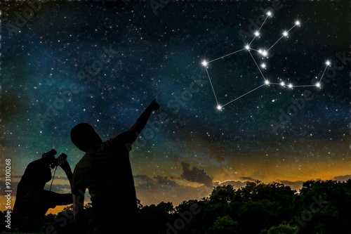 Pegasus constellation on night sky. Astrology concept. Silhouettes of adult man and child observing night sky.