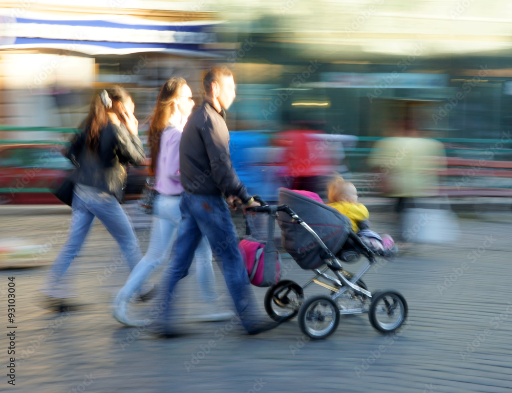 Young family with small child and a stroller Young family with small child and a stroller