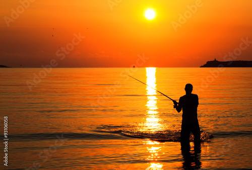 Fisherman silhouette at sunrise
