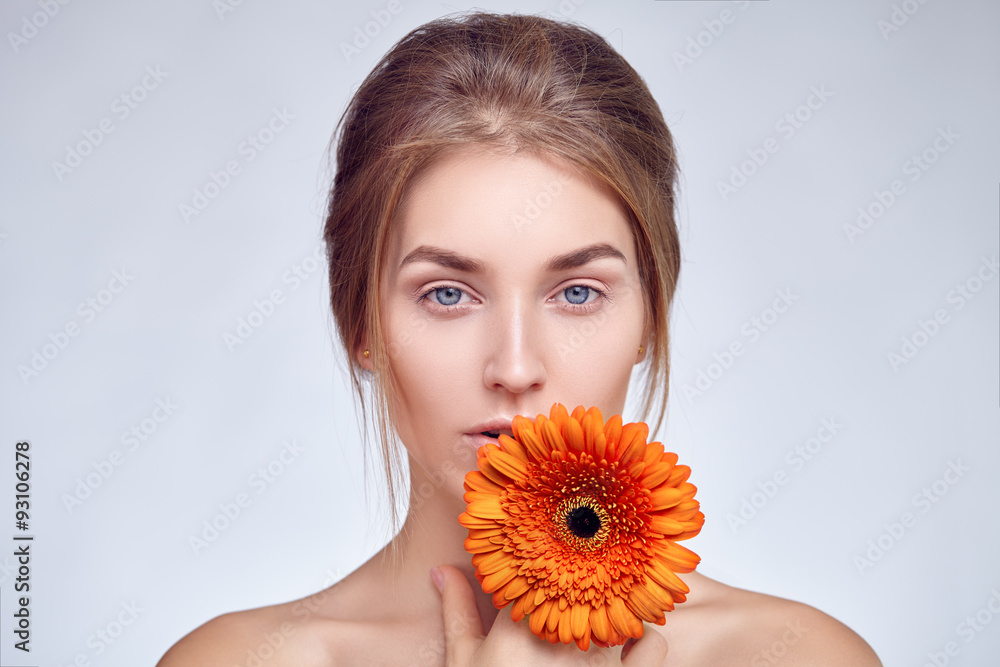 Close-up face of girl with flower in her hand