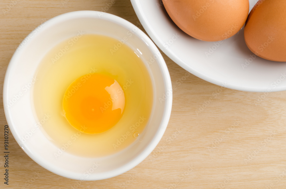 Egg yolk in the bowl on wooden background Egg yolk in the bowl on wooden background