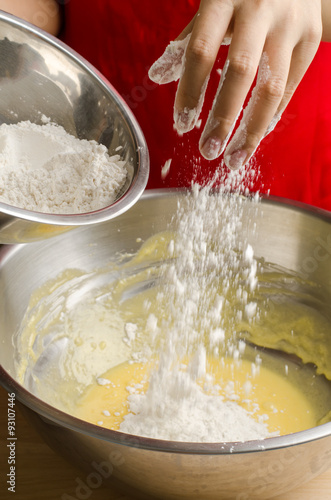 Pouring the flour into the mixture,making bakery