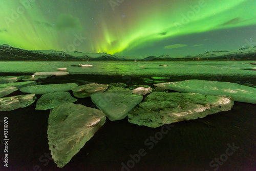 A beautiful green and red aurora over the Jokulsarlon lake, Ice