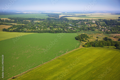 Aerial view of colza fields near the village