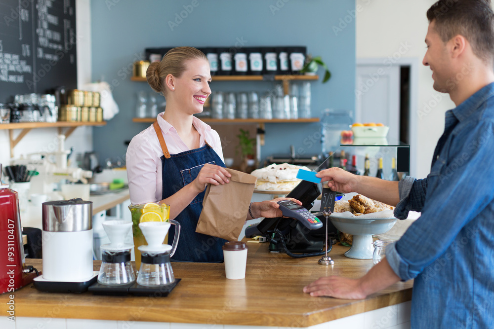 Barista serving customer in coffee shop Barista serving customer in coffee shop