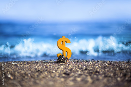 American Dollar currency icon is standing on the wavy sea side