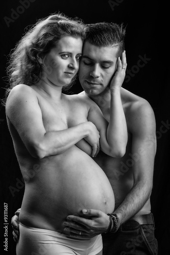pregnant woman with husband holding her belly