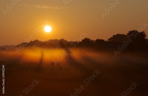 Colorful orange red sunrise with mysterious fog in early morning 