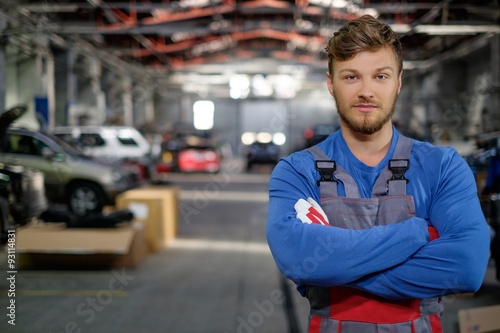 Cheerful serviceman in a car workshop