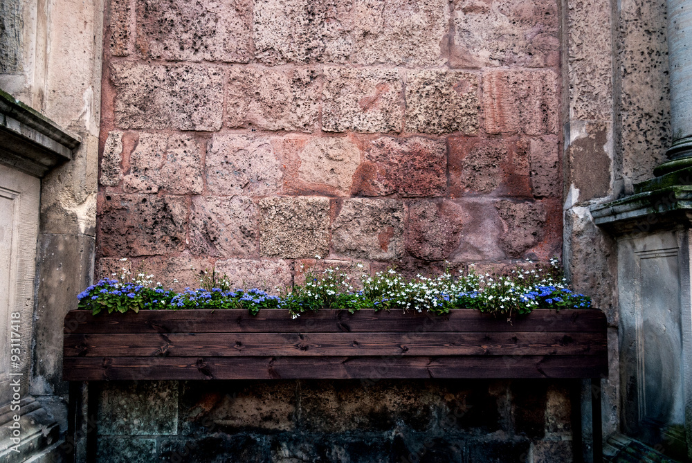Wooden box on legs with white and blue colors - the background brick wall on the side of the column. Wooden box on legs with white and blue colors - the background brick wall on the side of the column.