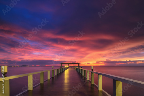 Wooded bridge in the port between sunrise.