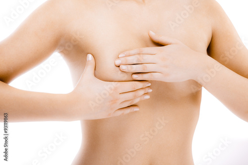 Woman examining her breast isolated on white background 