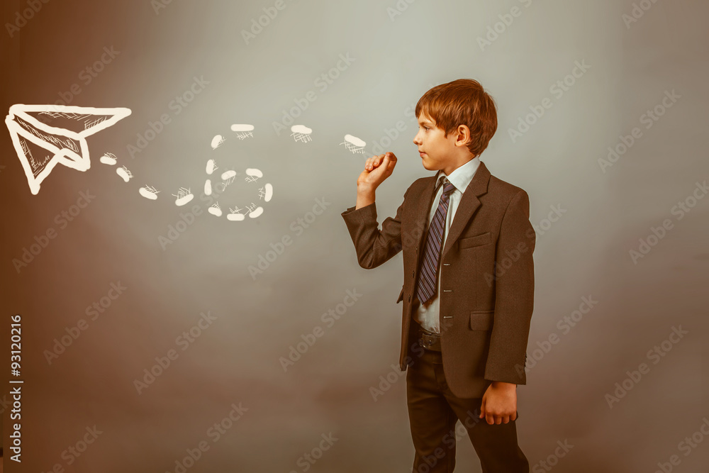 Teenage boy in suit businessman admits paper airplane strategy a Teenage boy in suit businessman admits paper airplane strategy a
