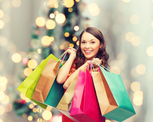 smiling woman with colorful shopping bags