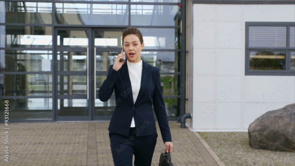 Slow motion video of confident businesswoman leaving from office. Beautiful professional is on call. She is walking outside office building. Slow motion video of confident businesswoman leaving from office. Beautiful professional is on call. She is walking outside office building.
