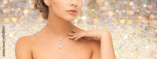 woman wearing shiny diamond pendant