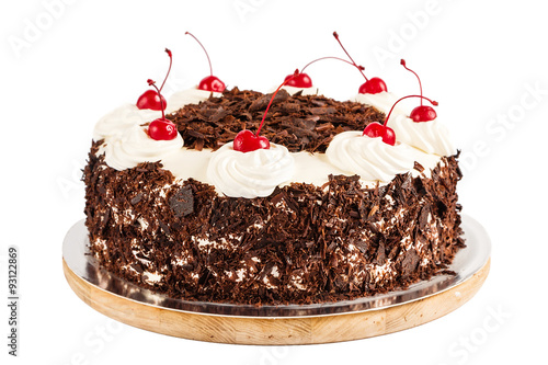 Black forest cake decorated with whipped cream and cherries