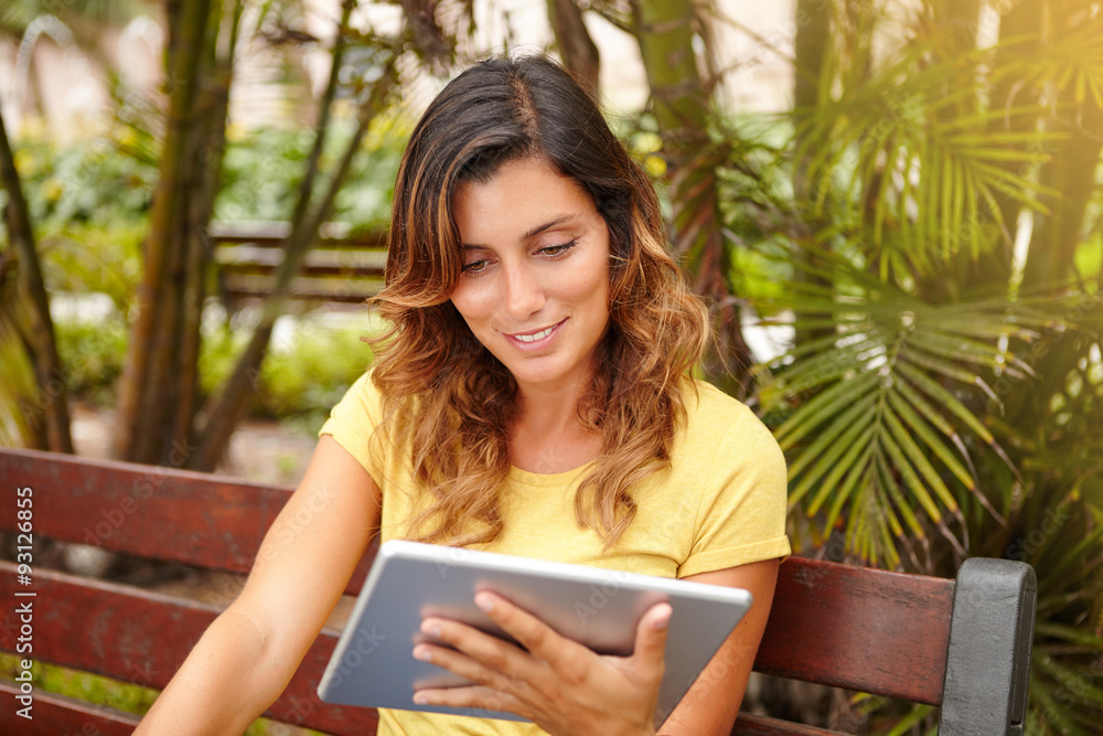 Fototapeta premium Young lady toothy smiling while using tablet