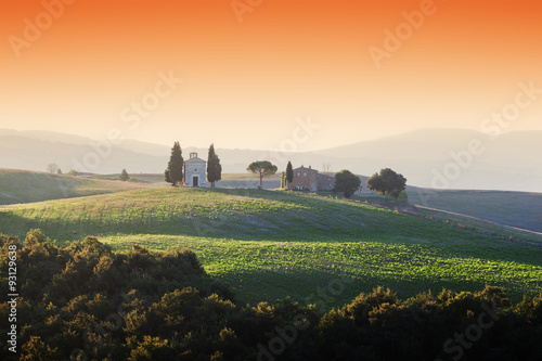 Tuscany landscape at sunrise with a little chapel of Madonna di Vitaleta, Italy.
