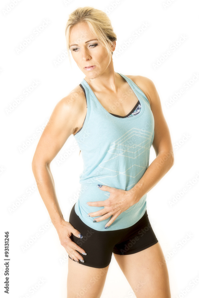 woman in blue fitness tank top hand on stomach woman in blue fitness tank top hand on stomach