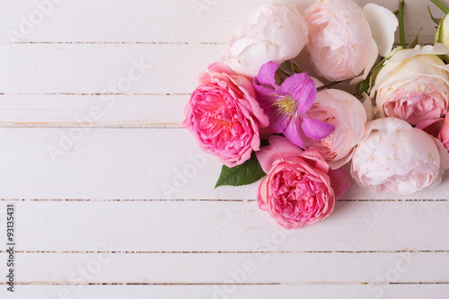 Sweet pastel roses on white  wooden background. © daffodilred