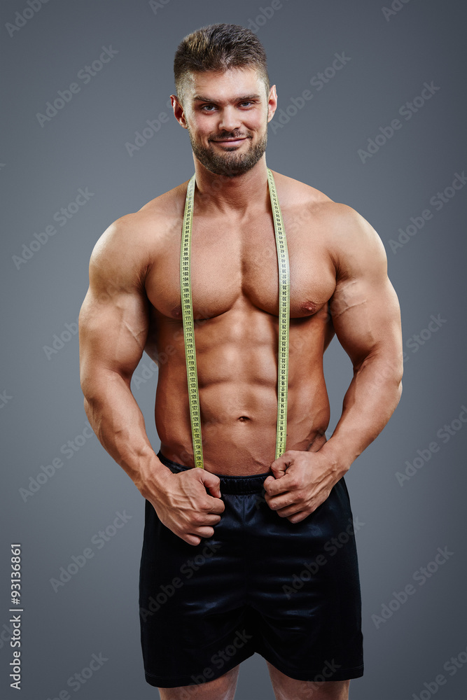 Premium Photo  Man body and tape measure on abdomen in studio on gray  background health fitness and male model with measuring tape for abs to  track exercise training results muscle goals or weight loss target