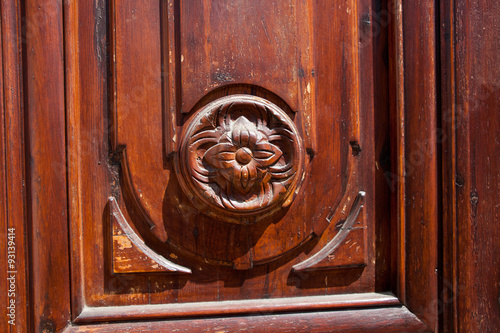 Old wooden flower detail on a door photo