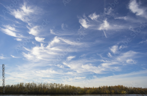 Beautiful clouds on a blue autumn sky . © amarinchenko106