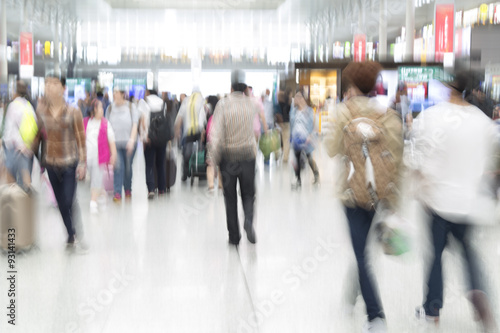 Traveler silhouettes in motion blur, airport interior