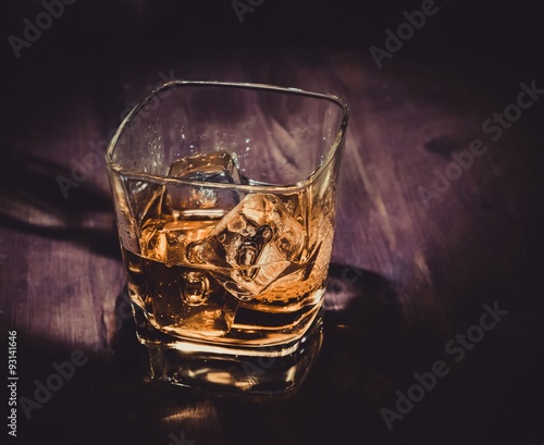 top of view of glass of whiskey on wood table  warm atmosphere  time of relax with whisky