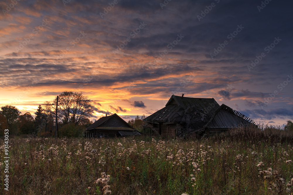 an abandoned village on the background of the autumn sunset. an abandoned village on the background of the autumn sunset.