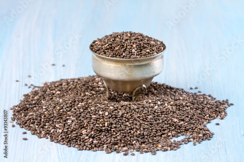 Chia seeds on a blue wooden background