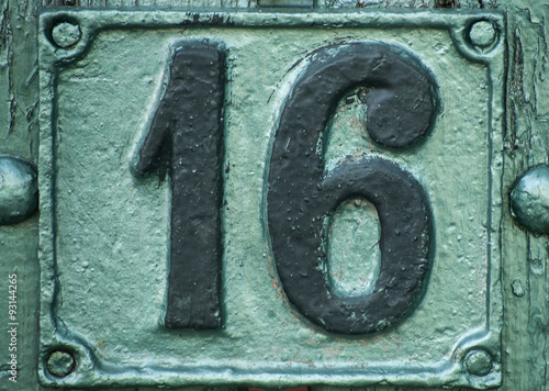 Old retro weathered painted cast iron plate with number 16