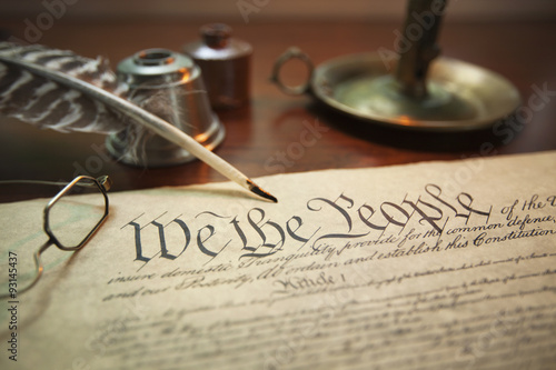 United States Constitution with quill, glasses and candle holder photo