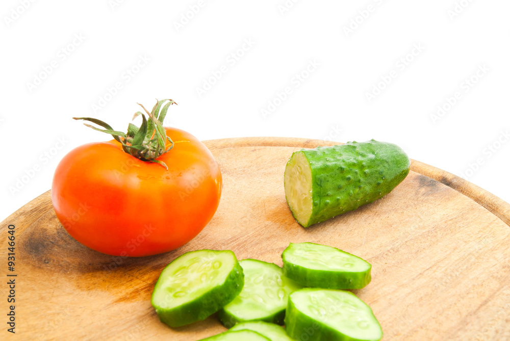 cucumber and tomato on wooden cutting board cucumber and tomato on wooden cutting board