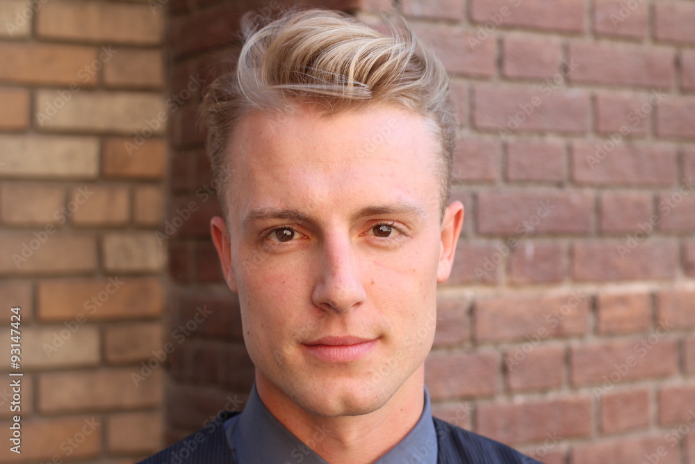 English gentleman beauty concept. Portrait of young and handsome man posing over brick background. Close up with copyspace. English gentleman beauty concept. Portrait of young and handsome man posing over brick background. Close up with copyspace.