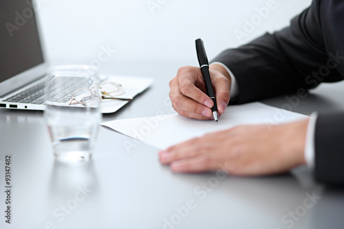 Close-up of male hands with pen over document, business concept