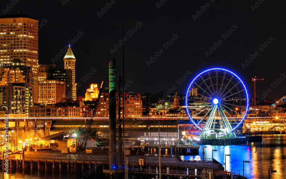 Seattle waterfront and skyline at night with lights and reflections