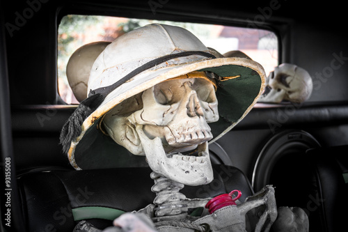 Laughing skeleton as a passenger in an old car ready for the Day of the Dead or Dia de los Muertos