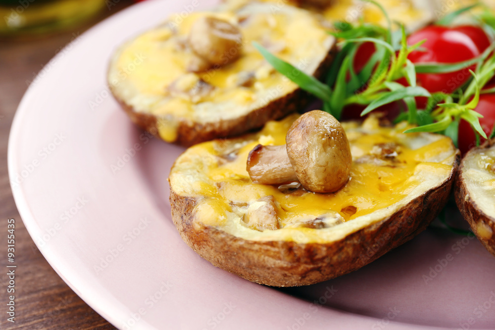 Baked potatoes with cheese and mushrooms on table close up