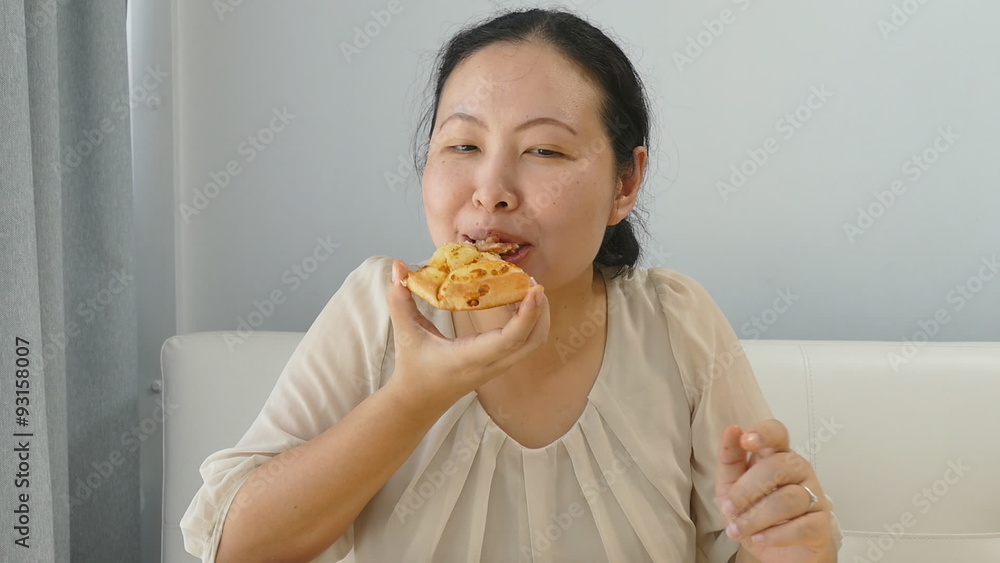 Fat Asian woman eating a slice of pizza
Fat Asian woman eating a slice of pizza