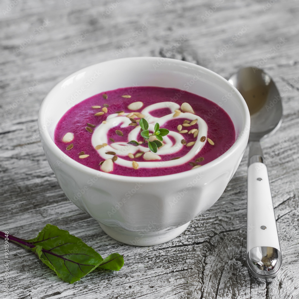 beet soup in a white bowl on bright wooden surface - healthy food beet soup in a white bowl on bright wooden surface - healthy food