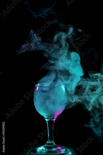 Aquamarine smoke in a glass. Halloween.