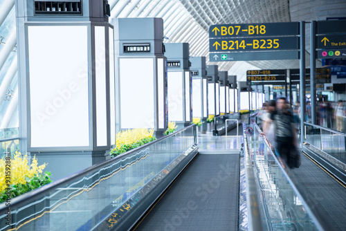 billboards beside the moving sidewalk