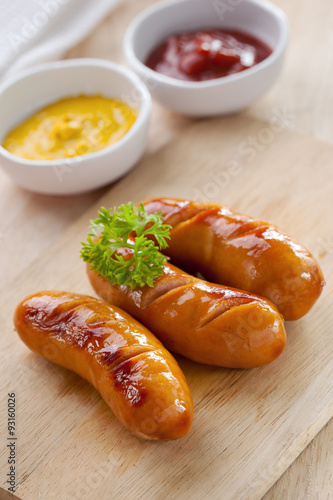 grilled sausage on wooden block