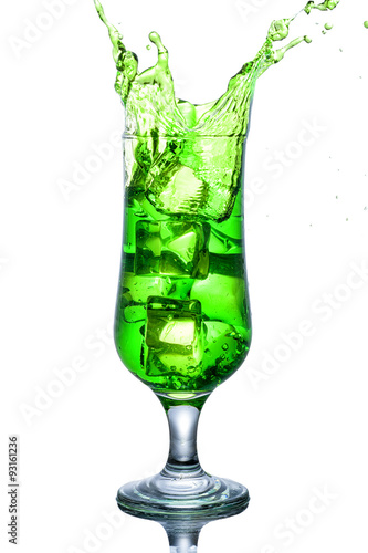 Green alcohol cocktail with splash isolated on white